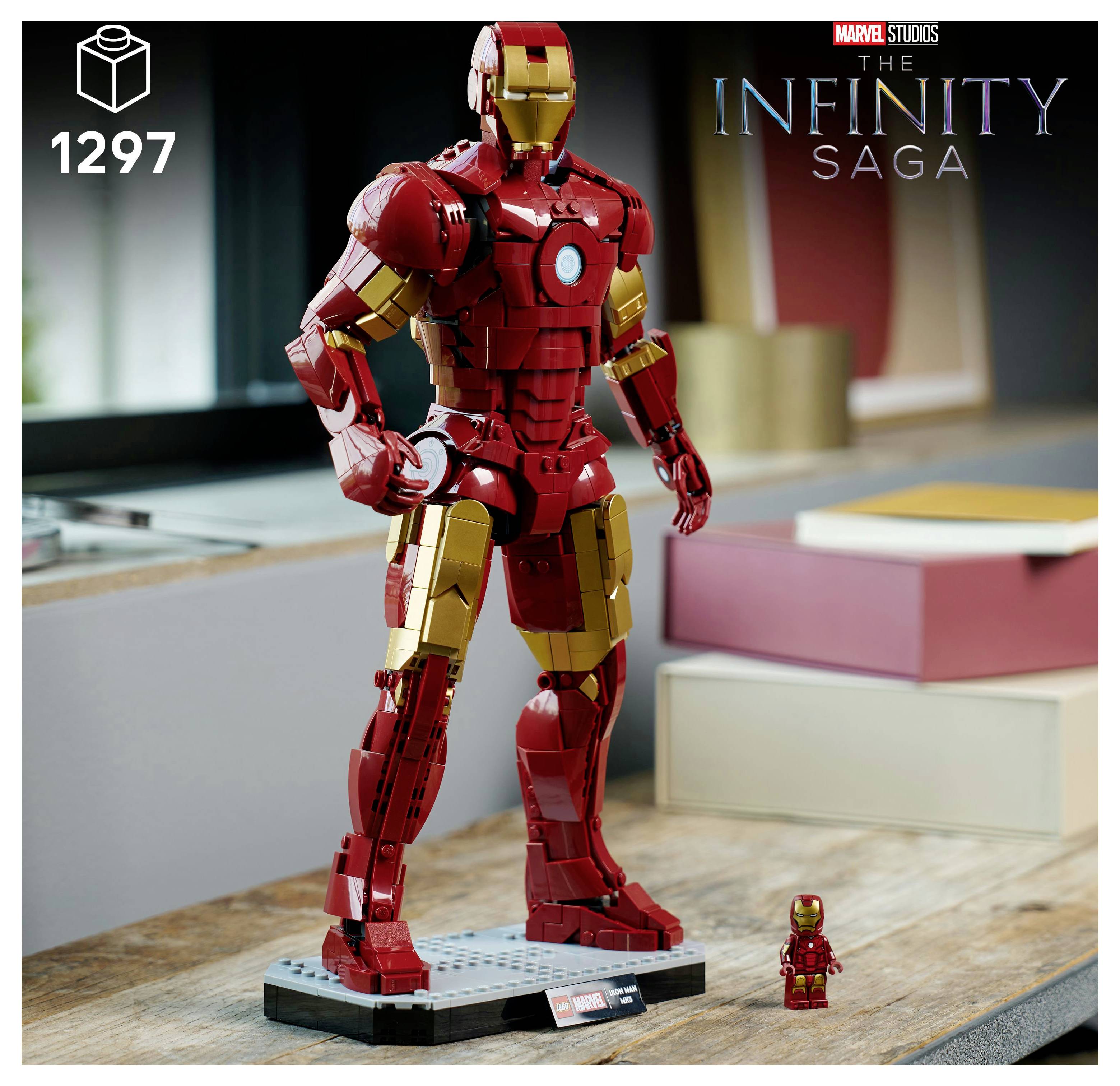 'Lego Iron Man figure from The Infinity Saga, set number 1297, stands on a desk with a small miniature version beside it.'