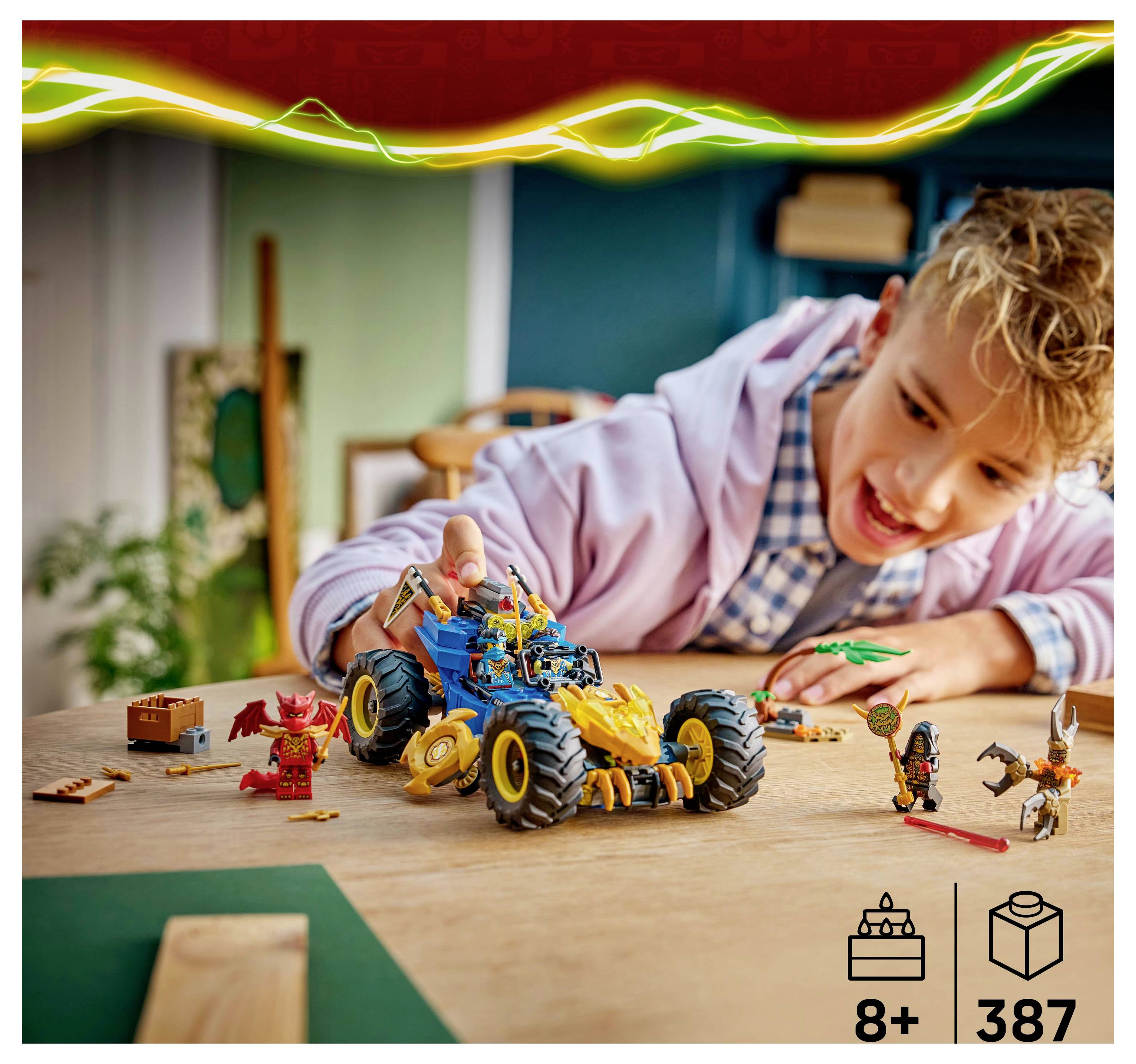 A child enthusiastically playing with a toy vehicle and action figures on a table, showcasing imaginative play. Suitable for ages 8+, includes 387 pieces.