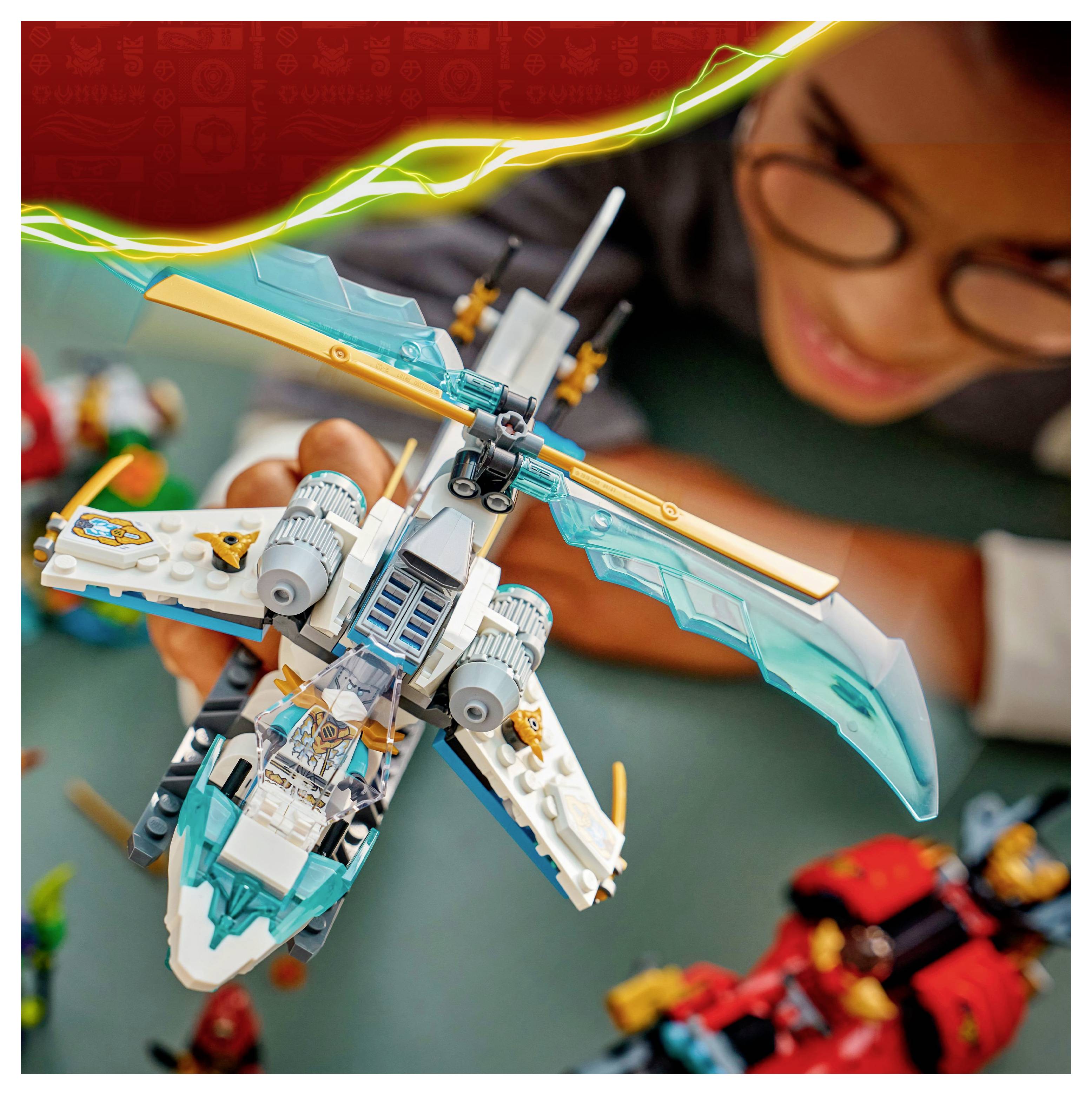 A child enthusiastically plays with a colorful, futuristic toy helicopter.