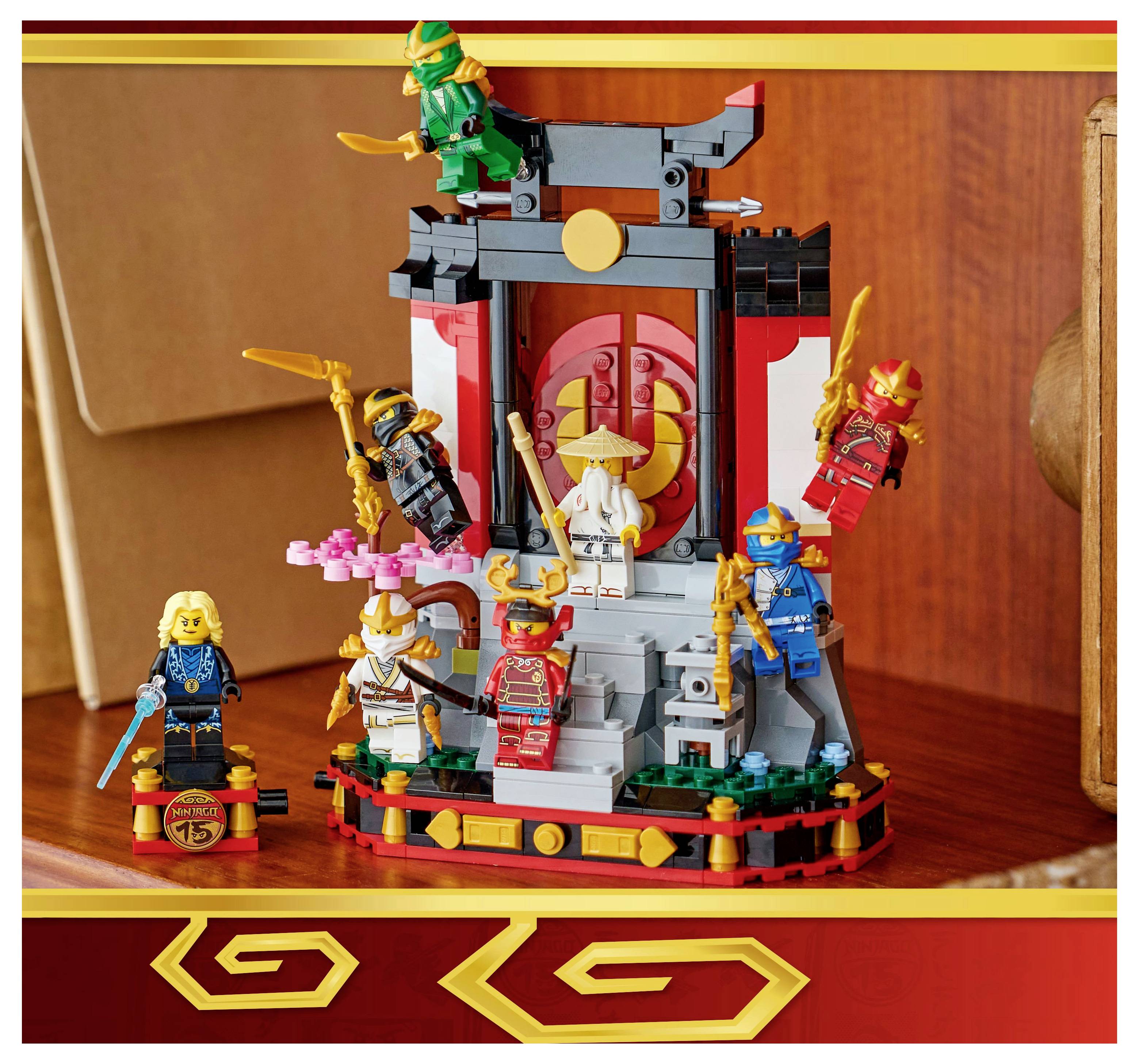 'Six colorful ninjas and a white-clad figure stand on a detailed LEGO stage with oriental design elements and decorative swords.'