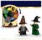 Two LEGO figures with wizard hats stand beside a spinning wheel featuring the four Hogwarts house crests.