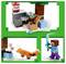 Lego set featuring Minecraft characters: Steve with a sword, a fox, rabbit, and a TNT block near a tree and chest.