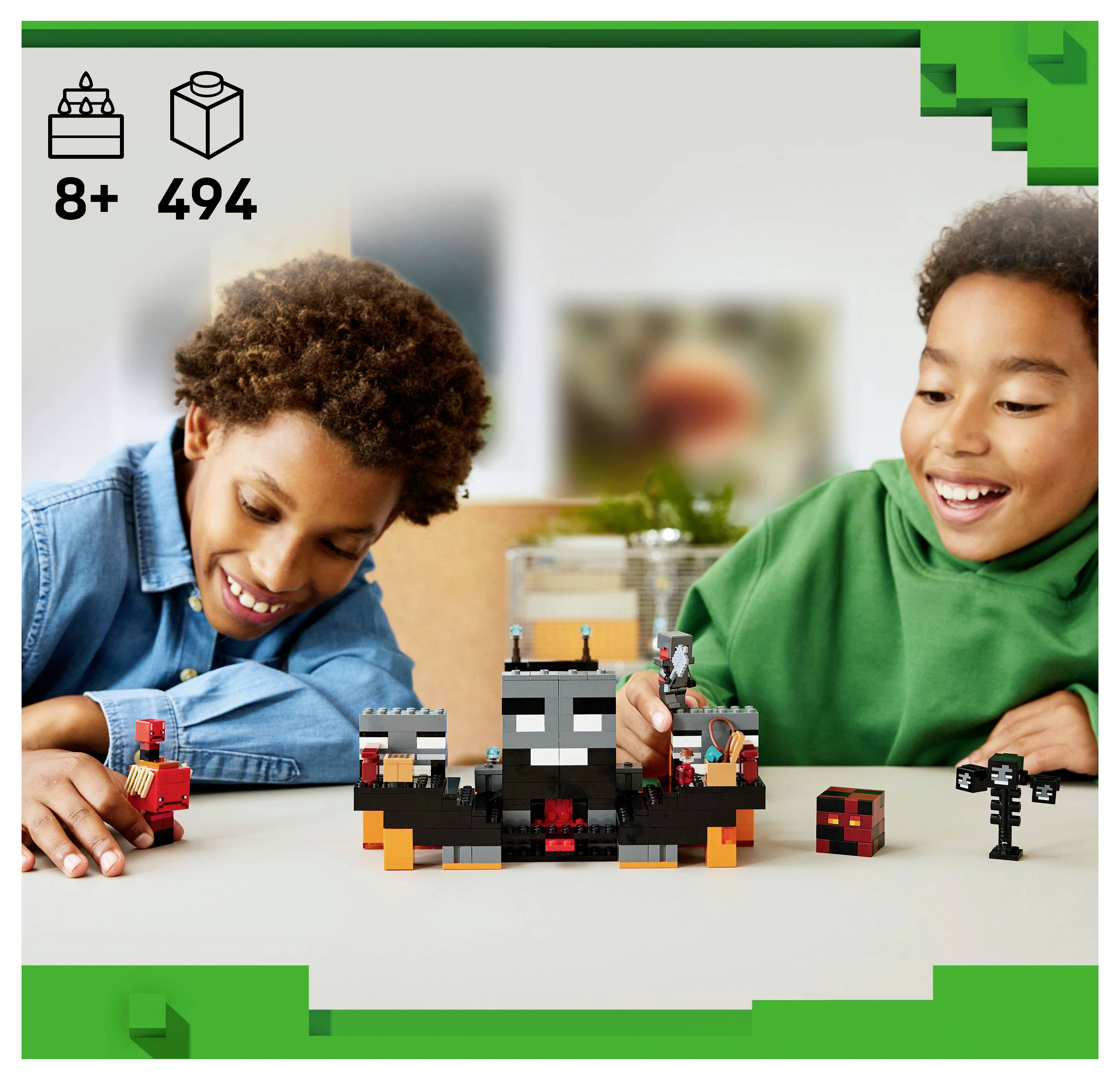 Two children smiling while playing with a Minecraft-themed LEGO set featuring a blocky creature, set against a neutral indoor background.