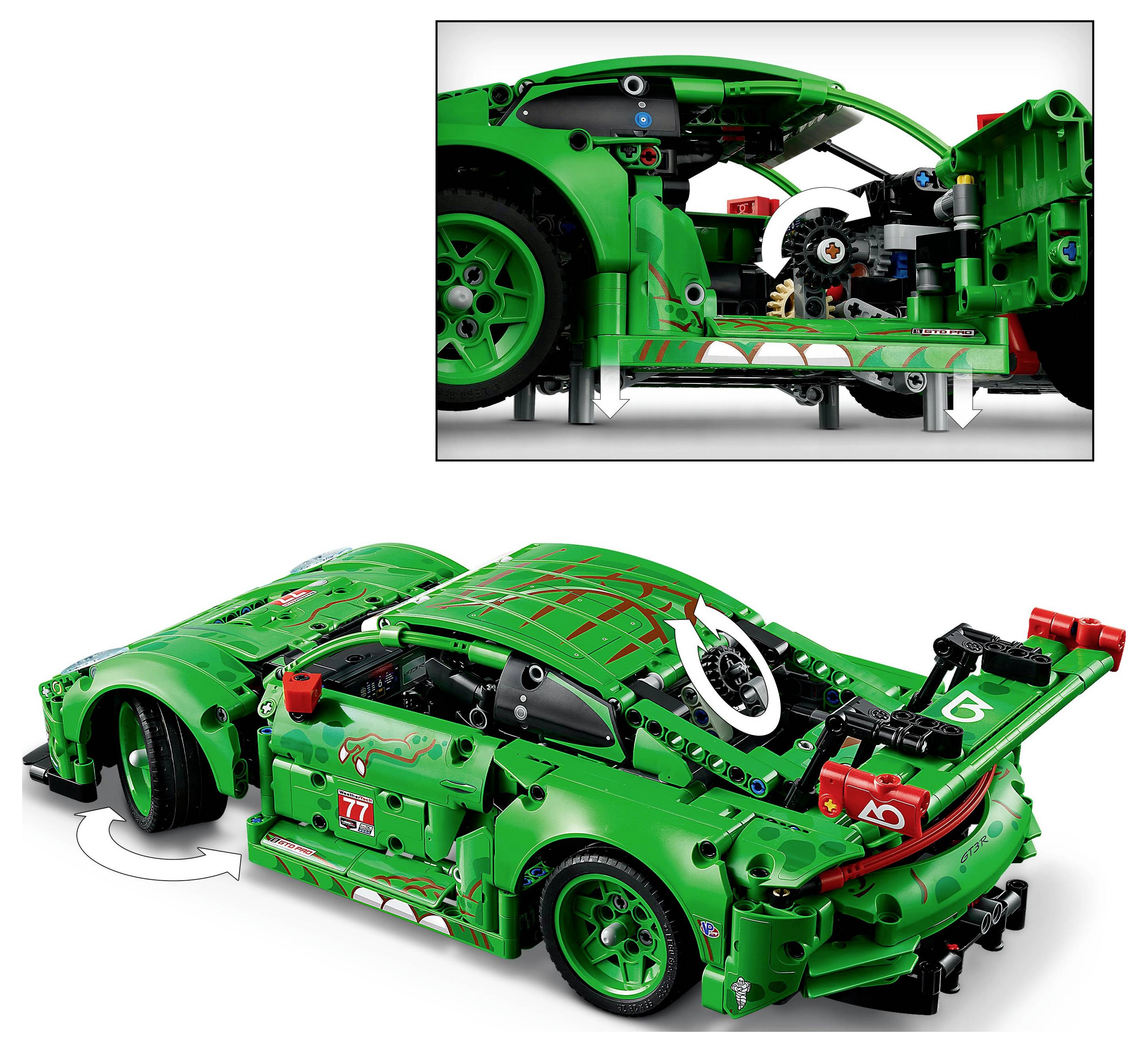 A green and red toy car with a detailed design, movable parts, and visible interior mechanism, highlighting its assembly complexity.
