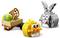 Three LEGO Easter-themed figures: a cart with an egg, a yellow chick, and a gray rabbit with pink nose.