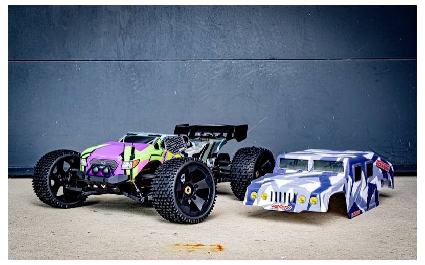 A remote-controlled racing car with colorful decals is next to a separate car shell designed like a camouflage-patterned vehicle.