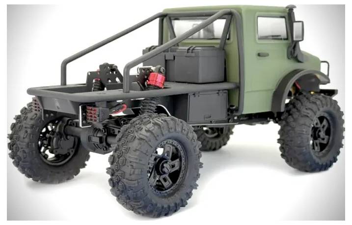 A green off-road model truck with large, rugged tires and a roll cage, viewed from the rear.