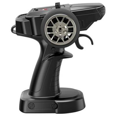 A black remote control with a large wheel on the side, typically used for steering remote-controlled cars, showing various buttons and a trigger.