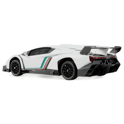 A white sports car with decorative stripes on its side, featuring a large rear spoiler and distinct black wheels, viewed from behind.