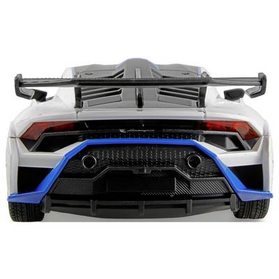 A sleek sports car viewed from the rear, showcasing a large spoiler, dual exhausts, and red taillights, emphasizing speed and aerodynamics.