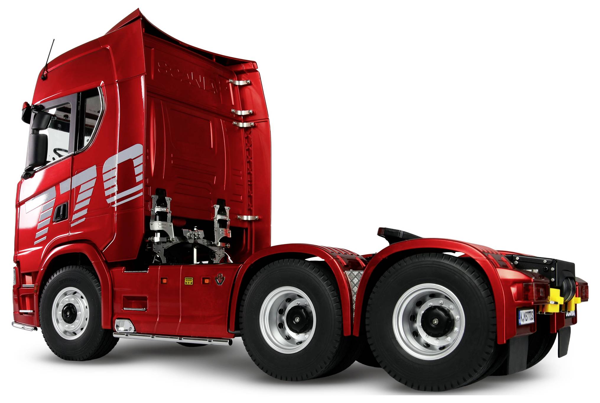 A red semi-truck cab with six wheels, without a trailer, viewed from the side, showcasing its streamlined design and robust build.