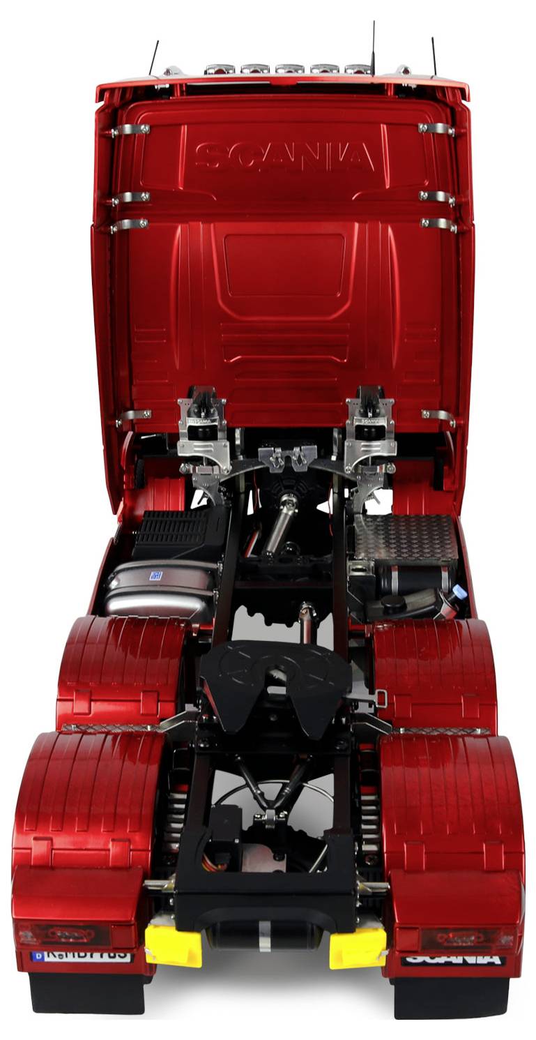 A red truck viewed from the rear, showcasing its detailed chassis and open hood, displaying the mechanical components underneath.