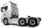A silver, heavy-duty semi-truck tractor with six wheels, viewed from the side. The trailer is absent, showing the rear wheels and cab.