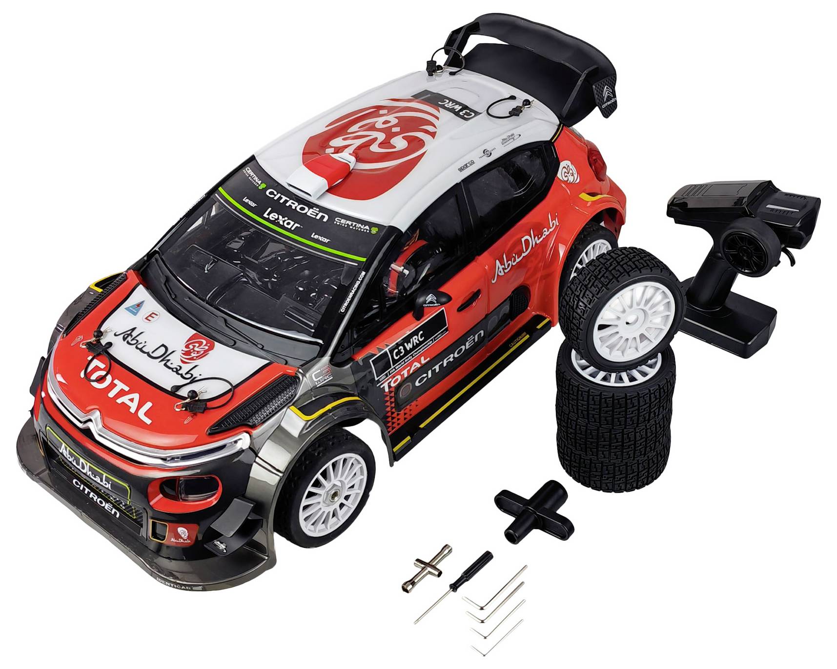 RC car kit featuring a Citroën rally car model with a remote control, four spare tires, and essential tools for assembly.