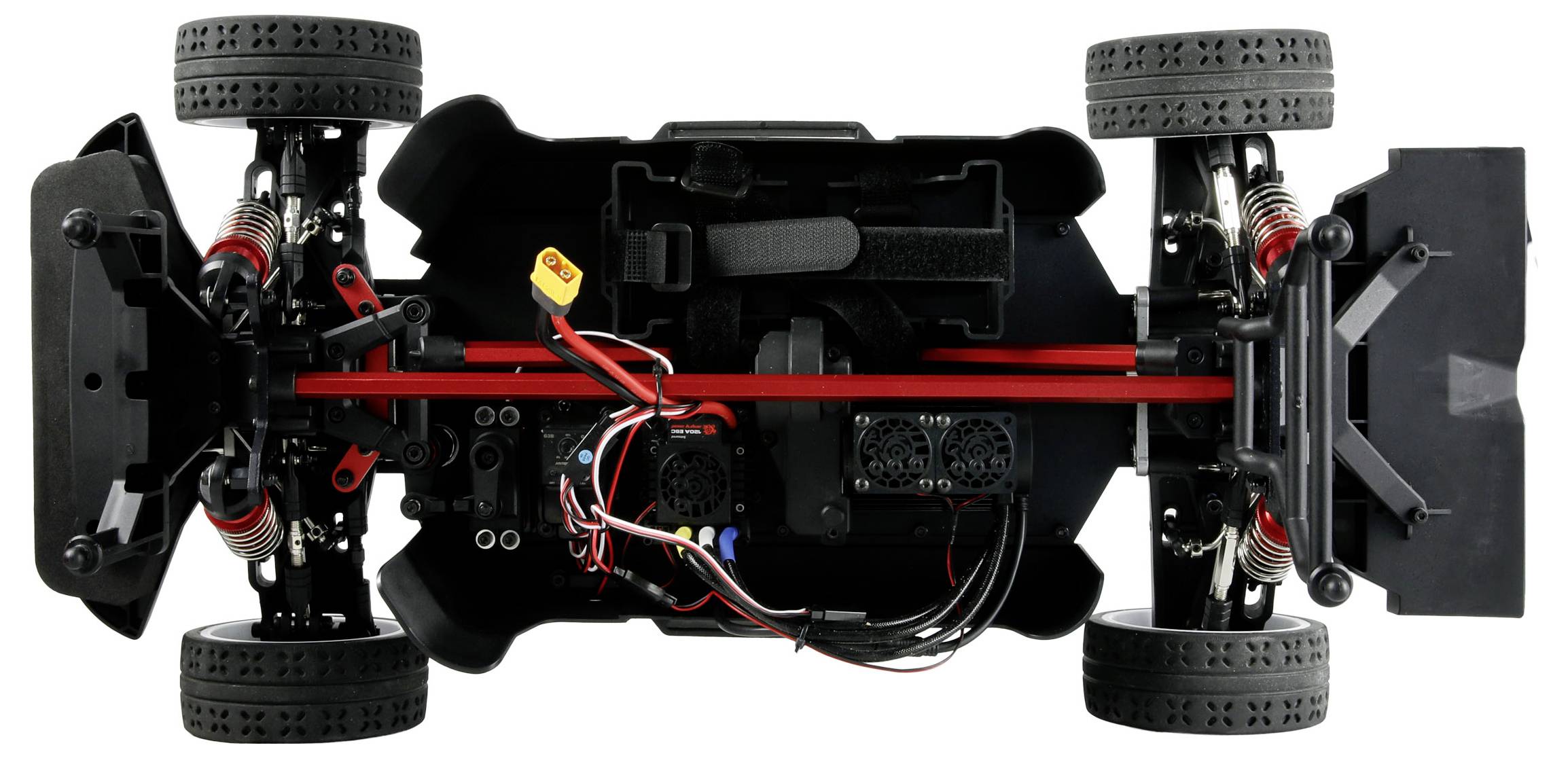 Aerial view of a remote-controlled car chassis showing tires, suspension, wiring, and motors.