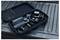 'A black carrying case opened on a truck bed reveals a gimbal stabilizer for cameras, neatly arranged with accessories.'