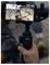 A person uses a gimbal to record video on a smartphone, capturing another individual climbing a rocky surface. The recording screen shows a red record button.