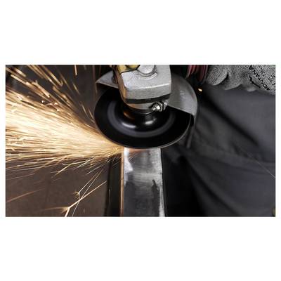 A person wearing gloves uses an angle grinder to cut metal, producing bright sparks.