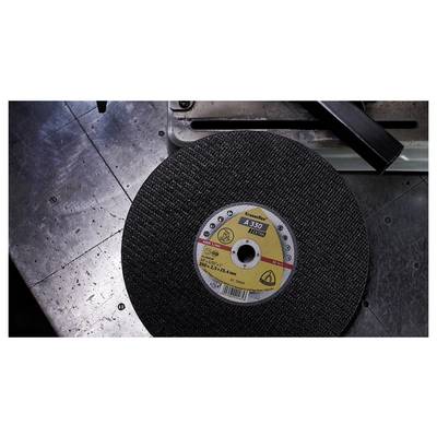 A metal-cutting disc labeled 'A30, 115x2.5x22.23mm' rests on a metallic workbench near a machinery component.