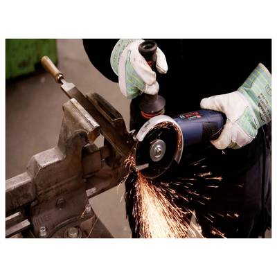 A person wearing gloves uses an angle grinder to cut metal, with sparks flying. They are working on a clamped piece in a workshop.