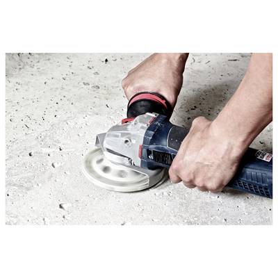 Hands using an electric sander to smooth a concrete surface.