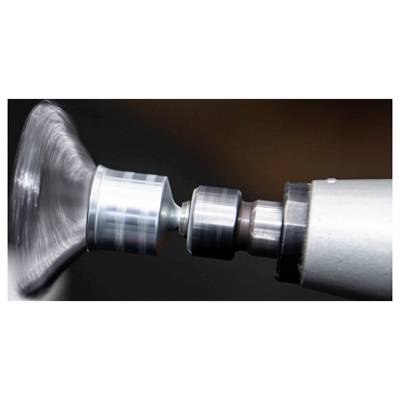 A metal or glass surface rotating rapidly on a lathe, showing details of mechanical precision and industrial craftsmanship.