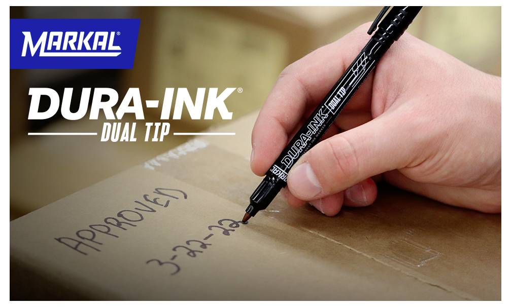 A hand uses a black 'DURA-INK DUAL TIP' marker to write 'APPROVED 3-22-22' on a cardboard box. Markal logo in the top left.