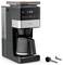 A sleek coffee maker with digital display showing '8:30'. Includes a carafe, filter, scoop, and cleaning tool. Brand 'KRUPS' visible.