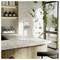 A sleek, modern kitchen with an L-shaped counter, plants by the window, and a digital tablet on the counter displaying 'Square'.