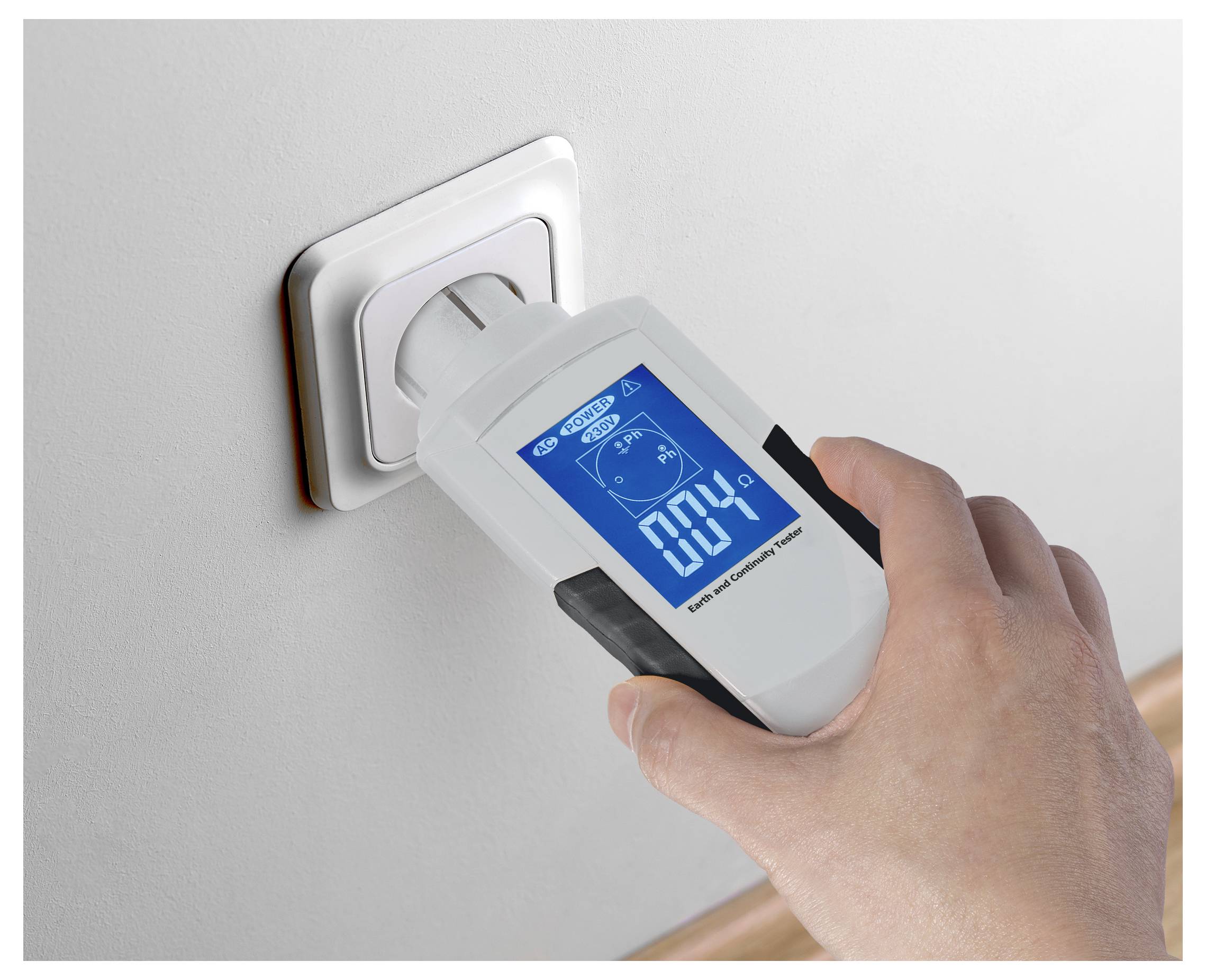 Handheld power meter plugged into a wall outlet, showing 0.04 watts on its digital display.