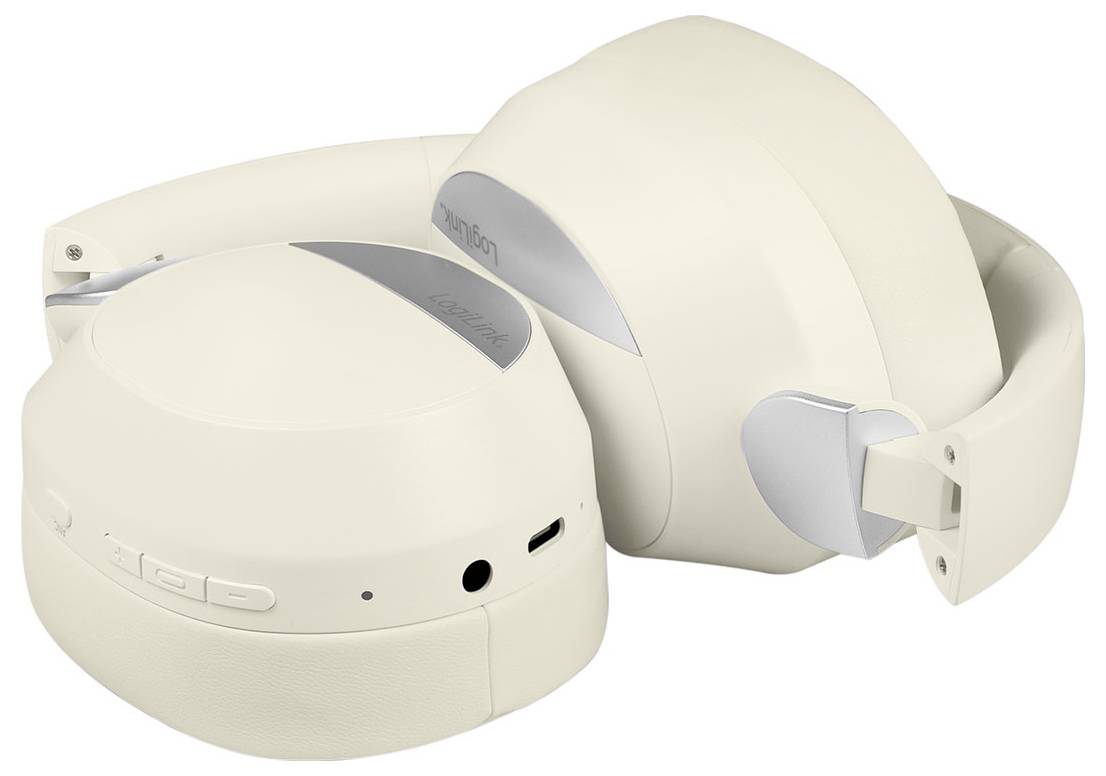 Beige over-ear headphones with silver accents featuring control buttons and ports on the ear cups, shown folded for portability.