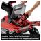 'Einhell garden tool with an open battery flap and removable battery. Text: Double Twin-Pack Technology: 4 battery slots for double runtime.'