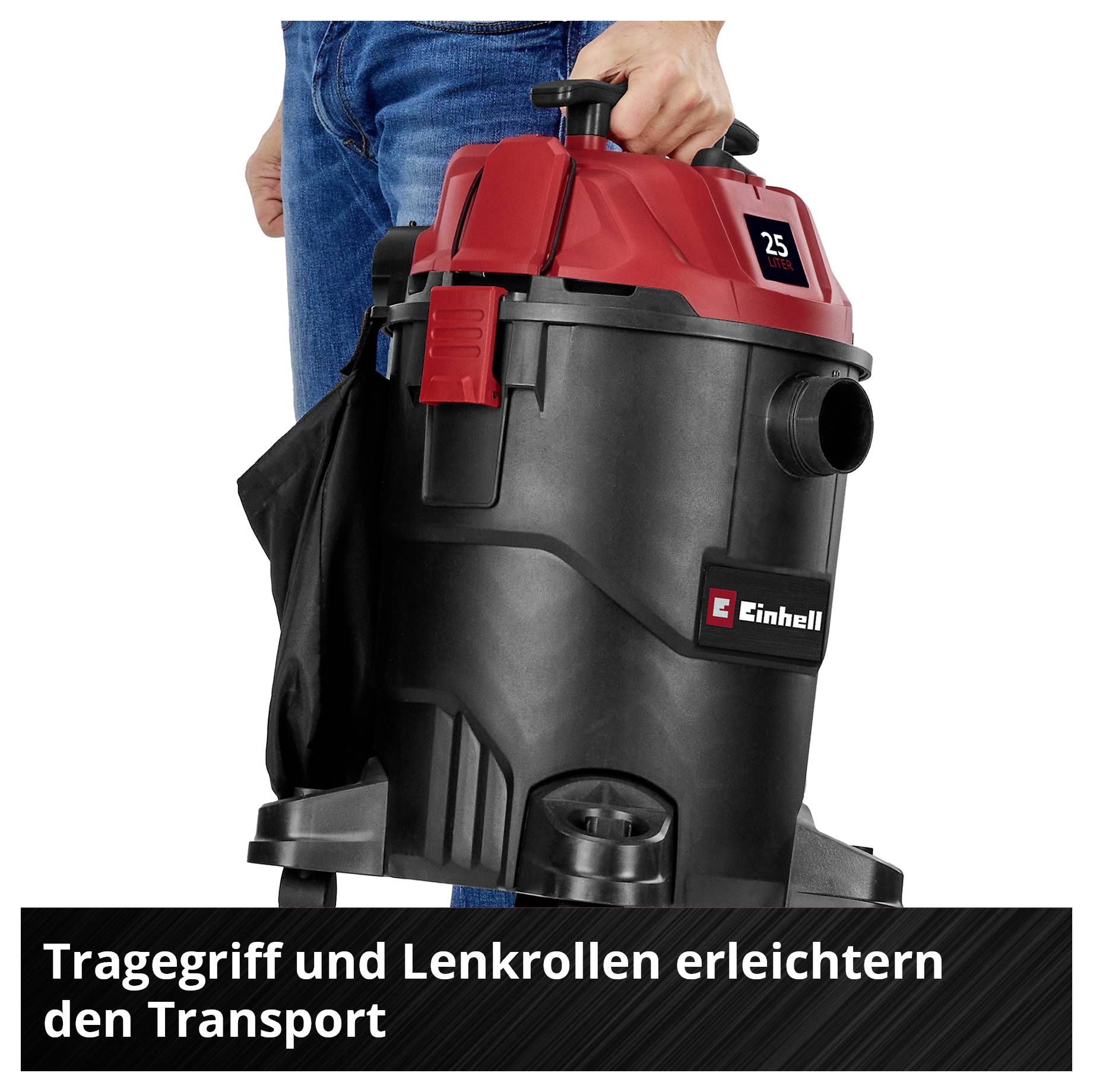 'Einhell vacuum cleaner with a red top and black body. One person holding the vacuum cleaner by its carrying handle.'