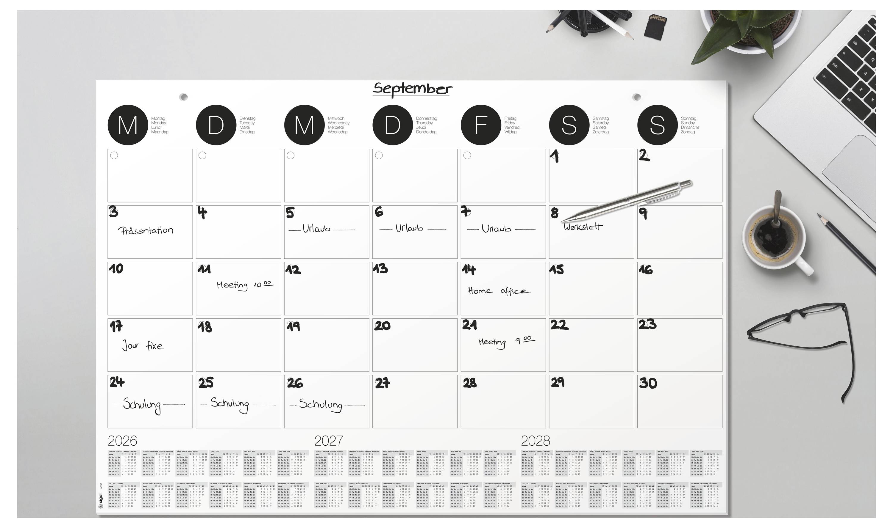 A desk with a September calendar, showing daily entries like 'Presentation' and 'Meeting 15:00', alongside a pen, coffee cup, and laptop.