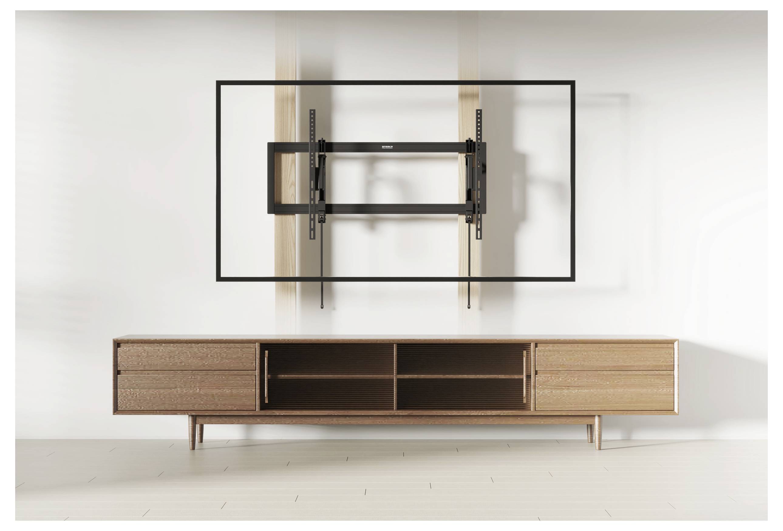 A wooden TV stand with open shelves and drawers below a wall-mounted TV bracket in a minimalistic, brightly-lit room.