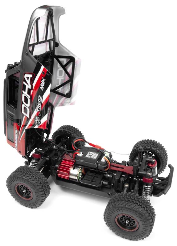 Remote control car with body lifted, revealing internal components like motor, chassis, and suspension. Racing design visible on car body.