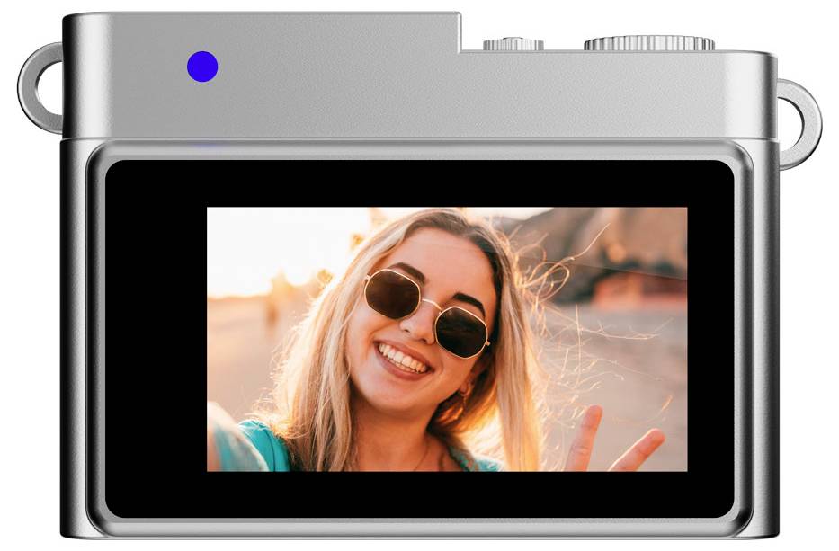 Rear view of a camera showing a screen displaying a smiling person wearing sunglasses and making a peace sign.