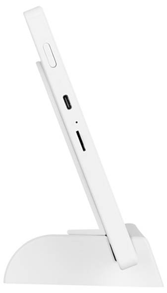 A white phone stands upright in a curved docking station. The side view shows volume buttons, a USB port, and a card slot on the phone.