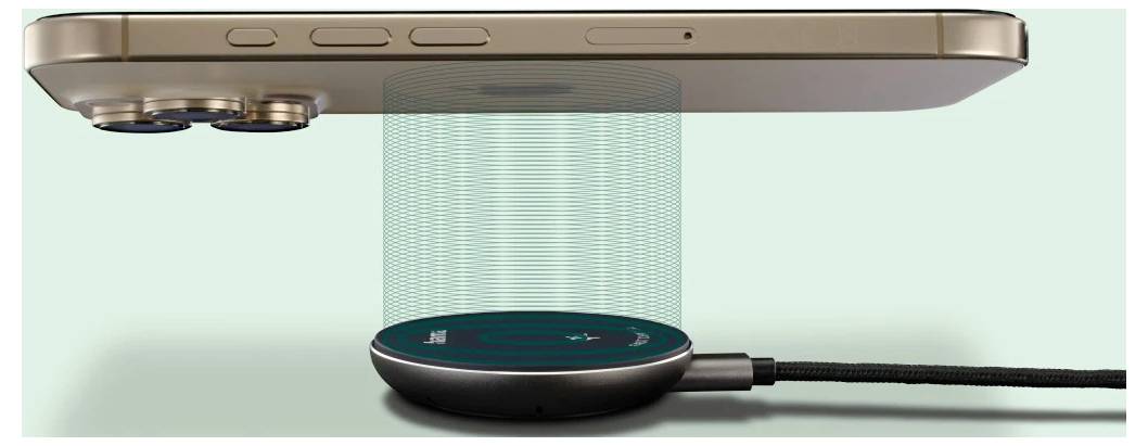 A smartphone is positioned above a wireless charging pad with a light beam effect indicating charging in progress.