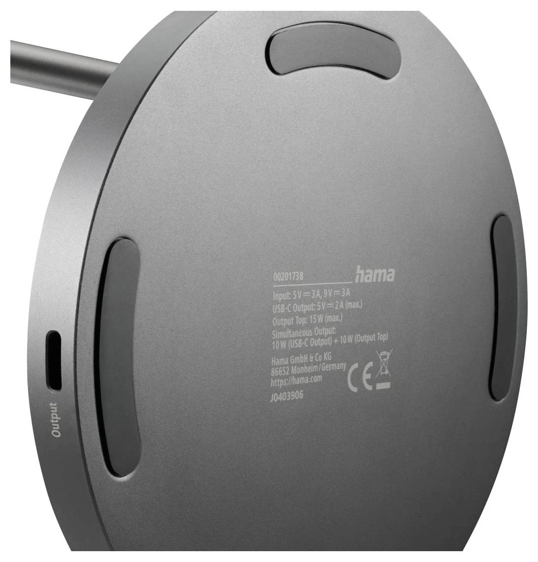 A round, gray electronic device with ports labeled 'output' and 'micro' on its side, showing specifications including input/output details.