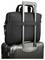 A black fabric bag with a strap is securely attached to the handle of a silver hard-shell suitcase, showing convenient travel functionality.