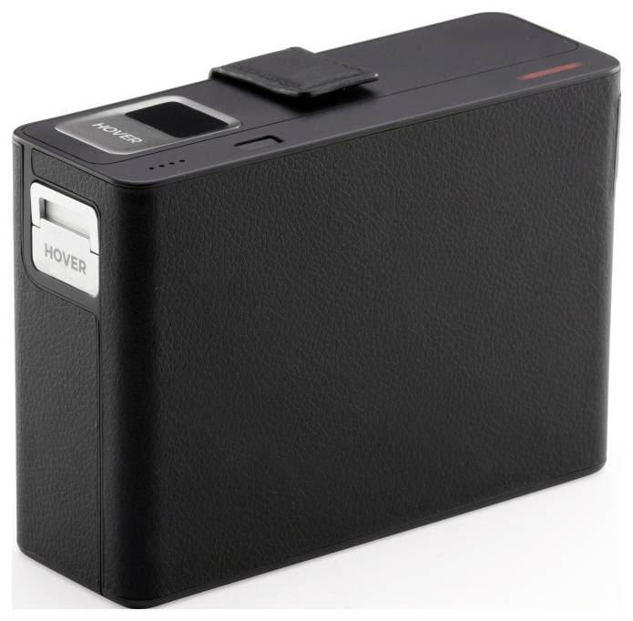 A black, rectangular camera with a sleek design, featuring a strap and a lens cover labeled 'HOVER', likely indicating the brand or model.