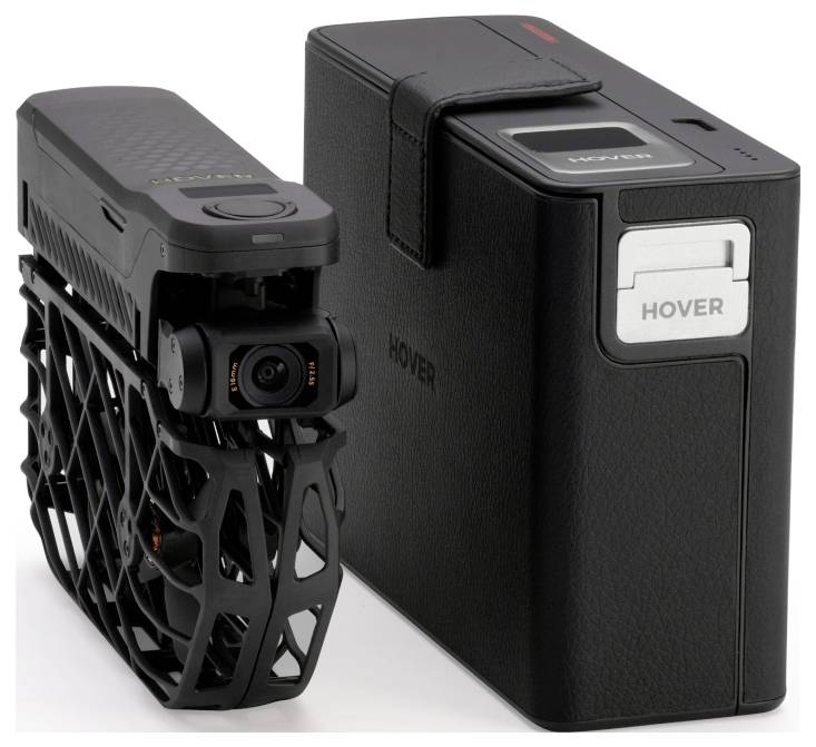 A compact black drone with protective cage sits next to its matching rectangular case, both branded with 'Hover'.