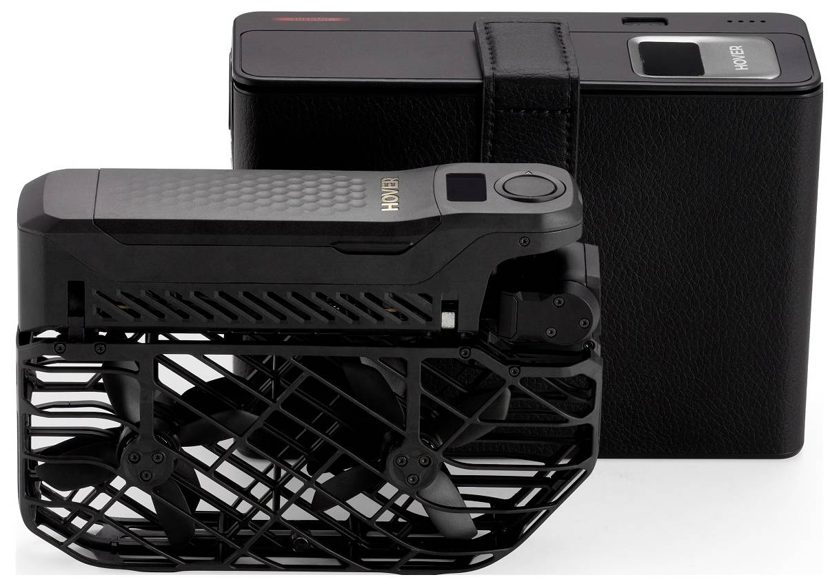 A compact, black drone with folding propellers next to a rectangular black case. The drone is designed for portability and easy storage.