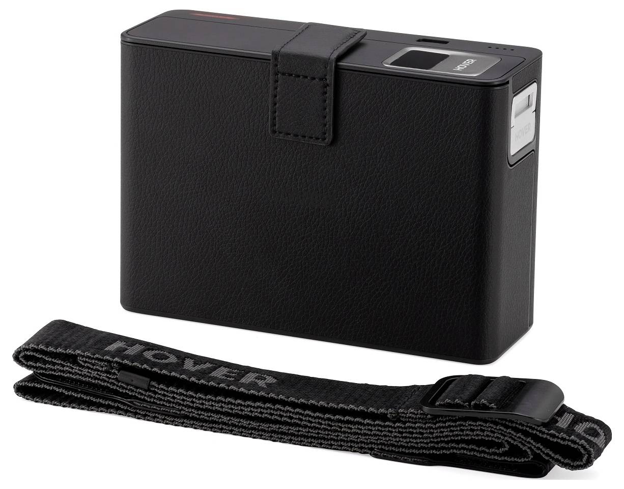 A black portable electronic device with a strap and button, resembling a sleek camera, set against a plain white background.