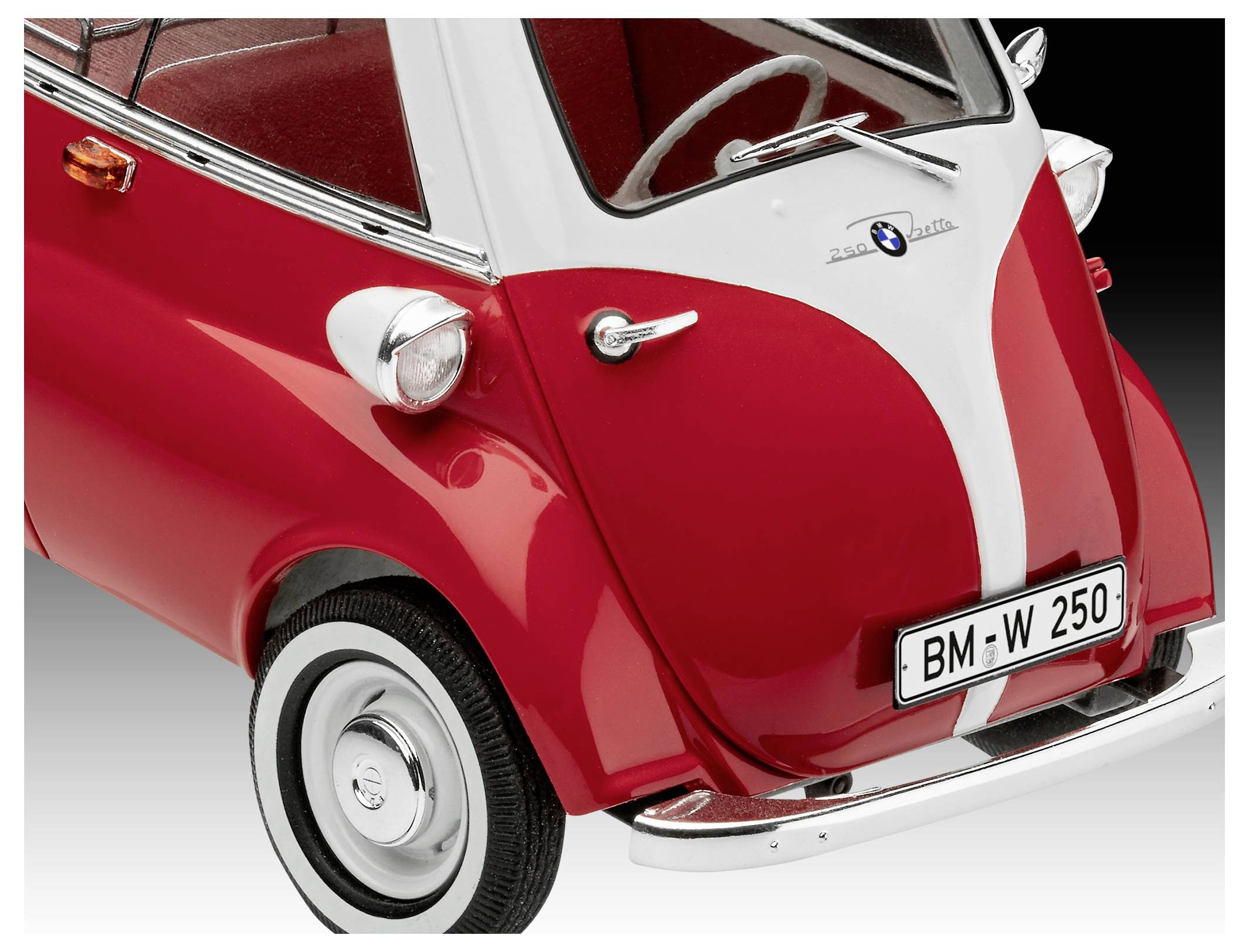 A red vintage microcar with a bubble-like design, showcasing its front view. The car has a chrome bumper and round headlights.