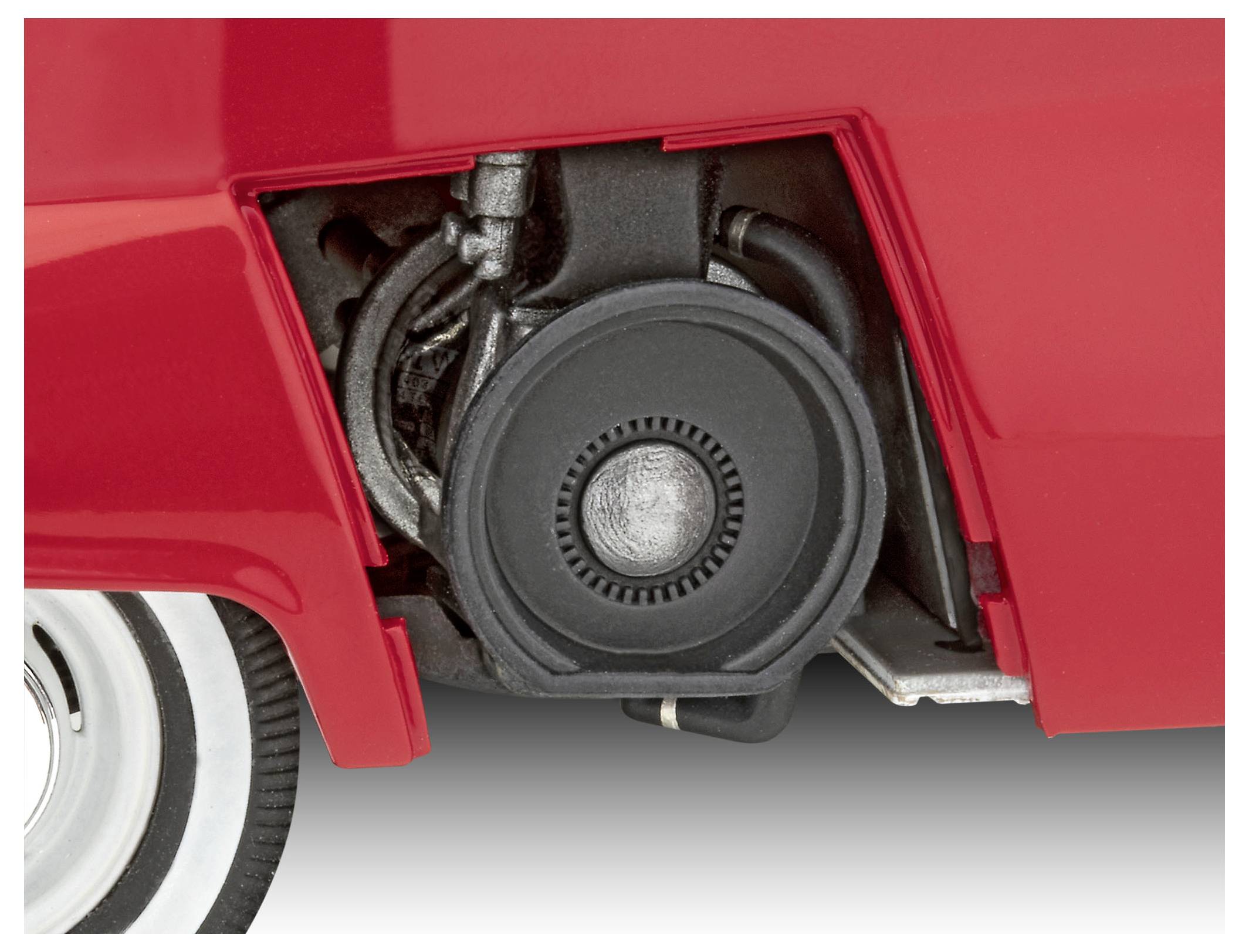 Close-up of a vintage scooter's wheel well, showcasing mechanical components and part of the red exterior.