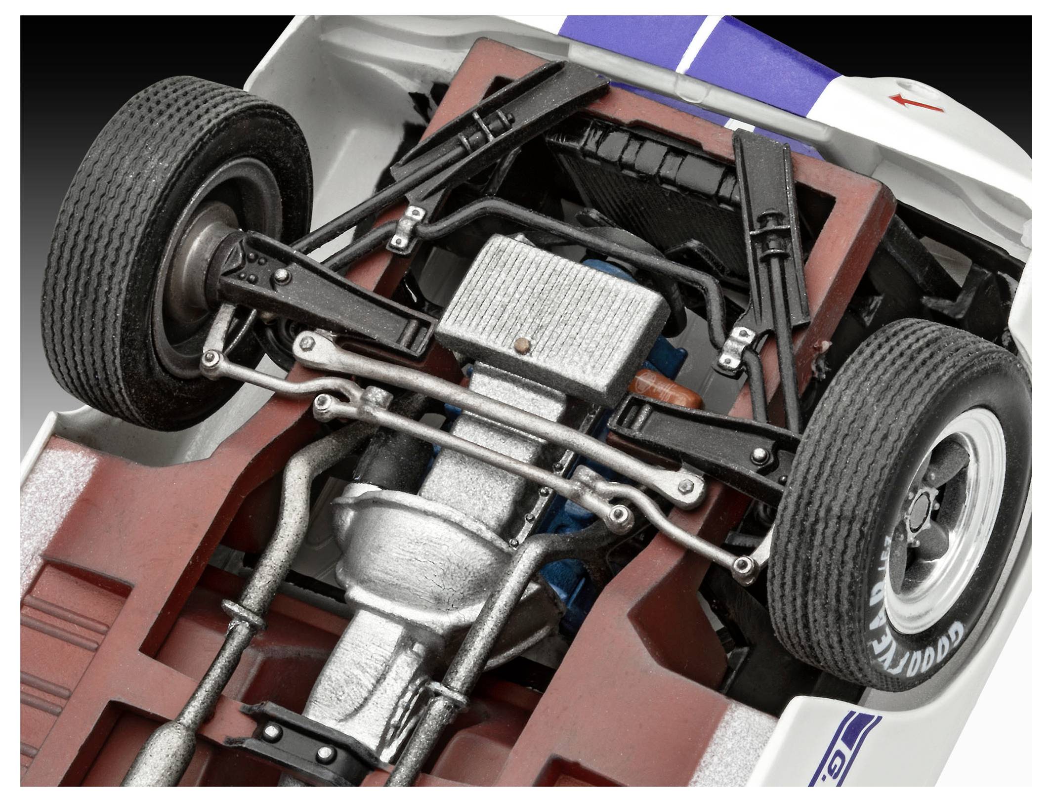 View of a model car's undercarriage showing detailed suspension, exhaust, and engine components, highlighting mechanical construction.