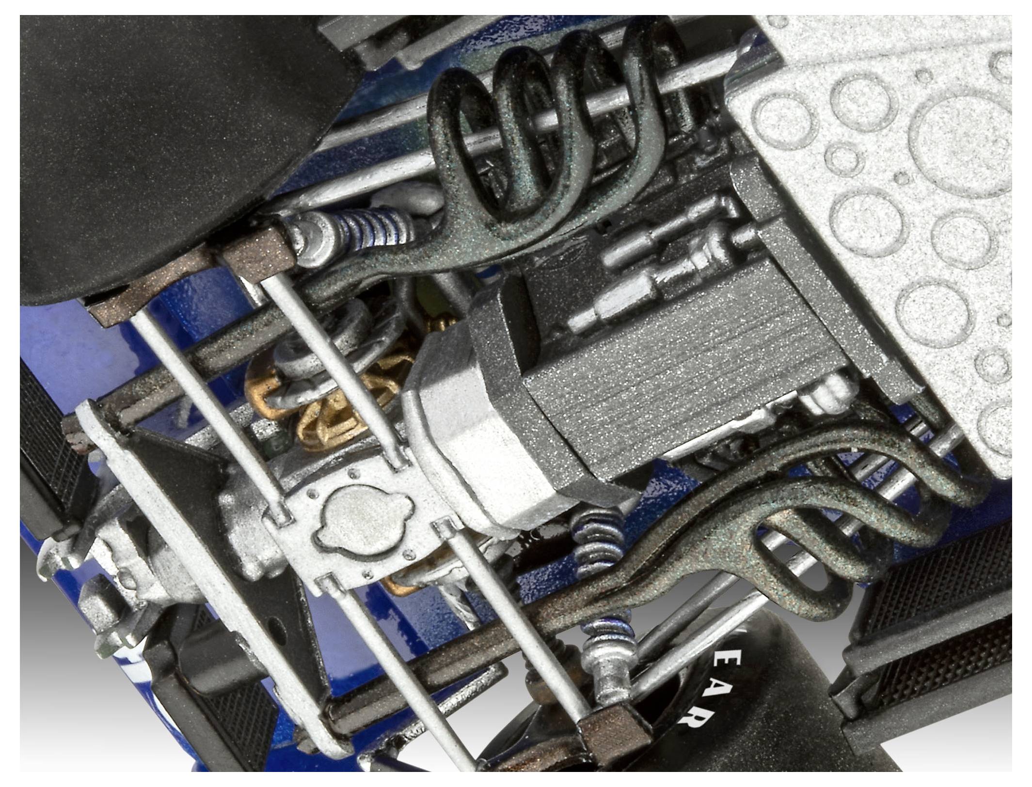 A close-up of a car engine displaying complex mechanical parts, including coiled springs, pipes, and a metal structure.