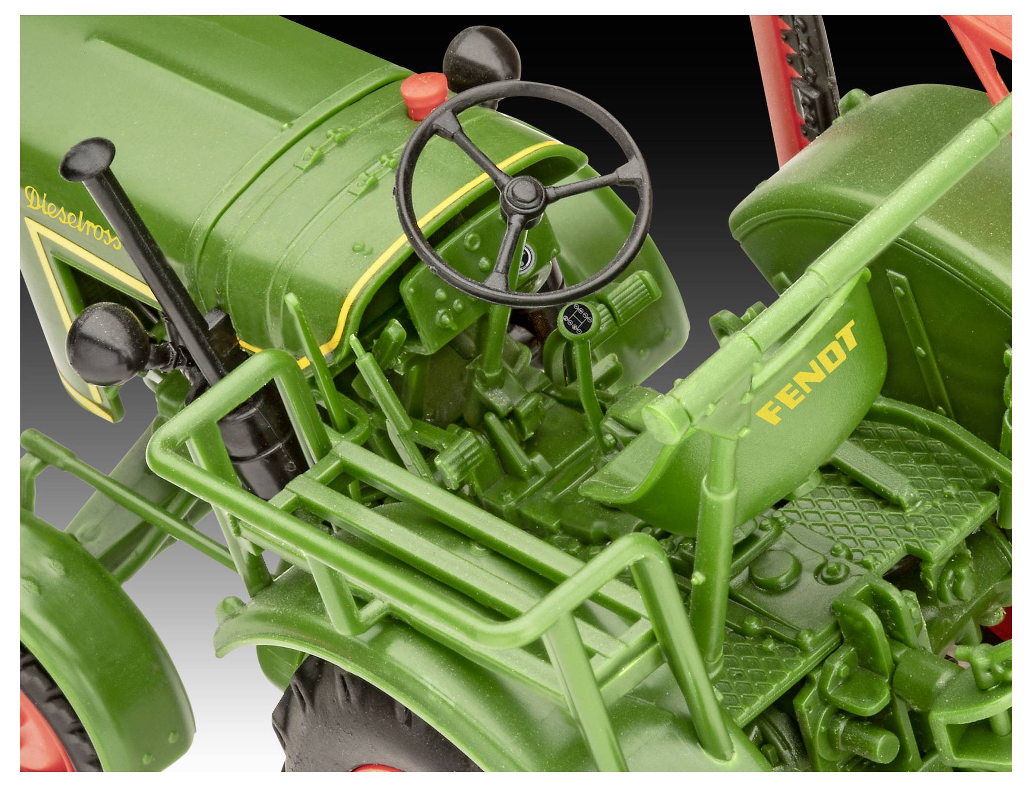Green model tractor with 'Fendt' on the seat, showing steering wheel and detailed controls. Tractor has red wheels and is against a gradient background.